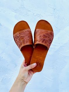 Eloquent and simple, the Mestiza Slides are a perfect everyday sandal that will rev up an outfit in a beautiful yet practical way. This versatile leather slide will soften and molds to your foot perfectly. Genuine embossed leather Teal, Tan or Black Handmade in Mexico ﻿Pro-tip! These fit wide. If you are a half size with a narrow foot, size down. Everyday Sandals, Leather Slides, Dressed Down, Embossed Leather, Slides, Leather, Black, Mexico