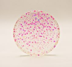 a pink and white plate with sprinkles on it