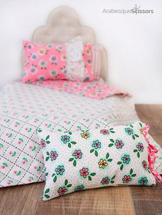 a bed with pink and green flowers on it