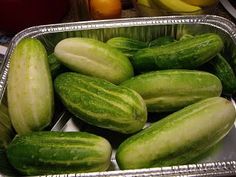 several cucumbers are sitting in tins on the counter