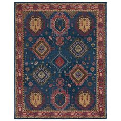 a blue rug with many different colors and designs on it, including an ornate design