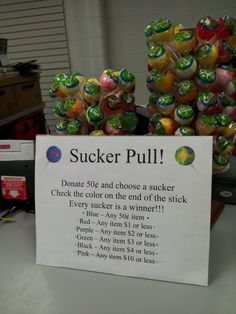 there is a sign that says sucker pull on the counter in front of some candy