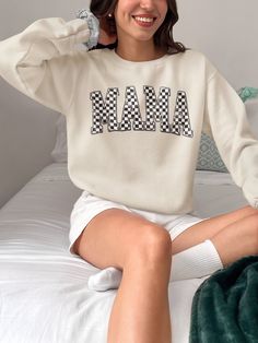 Make a bold statement with cool and trendy Grunge Checkered MAMA Sweatshirt! This urban streetwear style sweatshirt features an eye-catching checkered MAMA print on it.  Sweater is made of high-quality soft cotton-polyester blend fabric. Sweatshirt offers both comfort and style, making it perfect for everyday wear. Whether you're running errands or hanging out with family, this sweatshirt is perfect choice. Available in a range of sizes to ensure the perfect fit for every mom. Available in 3 colors: sand, military green and white Material: medium-heavy fabric blend of 50% cotton and 50% polyester (8.0 oz/yd² (271.25 g/m Care instructions: Machine wash: cold (max 30oC or 90F)  Tumble dry: low heat Do not iron Do not dryclean Tip: For an oversized look that's chic and super trendy, consider Streetwear Long Sleeve Sweater With Lettering, Long Sleeve Sweater With Lettering For Streetwear, Oversized Retro Sweatshirt, Crew Neck Tops With Lettering For Winter, Trendy Long Sleeve Sweatshirt For Leisure, Trendy Leisure Tops With Ribbed Cuffs, Trendy Tops With Ribbed Cuffs For Leisure, Winter Long Sleeve Tops With Lettering, Varsity Long Sleeve Sweatshirt With Text Print