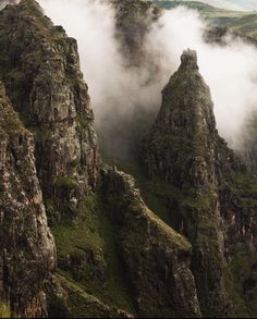 the mountains are covered in thick fog and low lying clouds as they sit on top of them