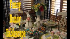 the table is set for easter dinner with bunny decorations