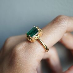 Read about our payment plans before proceeding.The Isis Emerald Scroll Diamond ring is an exquisite piece. Inspired by the details on architectural buildings in NYC, this ring features a stunning natural emerald framed by two baguette diamonds and round diamonds. Made for a true goddess with a touch of vintage vibe. Available in 14K solid yellow gold, white gold, and rose gold. 14K solid gold Natural 9*7mm emerald. Approx. 2.6ct. Comes with a certificate Natural baguette diamonds. Approx. 0.04ct Rings 2023, Ring Inspo, Emerald Cut Rings, Engagement Rings Bridal Sets, Baguette Diamonds, 18k Gold Ring, Architectural Details, Wedding Rings Vintage, One Ring