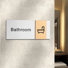 a bathroom sign on the wall next to a bathtub