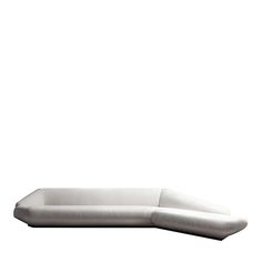 a white couch sitting on top of a wooden table