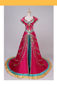 a pink and blue dress with gold trimmings on the bottom, sitting on a mannequin