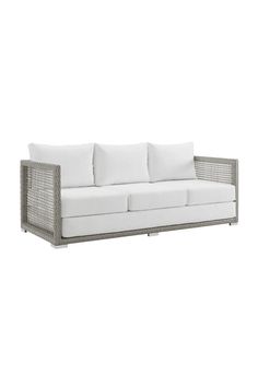 an outdoor sofa with white cushions and pillows on the back, in front of a white background