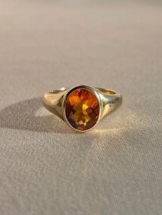 10k yellow gold signet ring by 23carat featuring a beautiful faceted citrine in a bezel setting. Excellent condition Size: 6.75 resizable* Weight: 5.7 grams Band: 11.0 mm (front), 3.0 mm (back) Citrine: 9.0 mm x 8.0 mm oval cut Hallmarks: 10k, water barrel and heart for 23carat Handmade to order, please allow for approximately 1 to 3 weeks before shipping For more details or customization options, emails us at info@shop23carat.com Antique Mens Rings, Water Barrel, Gold Signet Ring, Amethyst Gem, Pink Cotton Candy, Citrine Ring, Men's Rings, Emerald Diamond, Signet Ring