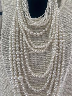 Stunning long multi-strand statement pearl necklace. Featuring a trendy layered chunky choker design. This cascade necklace showcases a beautiful waterfall of faux pearls in varying sizes, from delicate 2mm to bold 20mm. Perfect for adding a touch of elegance to any outfit, it's the ideal accessory for both casual and formal occasions. Make a statement with this eye-catching piece that effortlessly blends classic charm with modern flair. The necklace measures:  choker size 18" +4" (48 cm+10cm) Longest row : 46" (117 cm) Necklace drop: 23"(58cm) ----If you have any question please contact me---- I am inviting you to explore and enjoy my jewelry store; perhaps you will discover something unique for yourself or as a gift for someone special in your life. Thank you! https://www.etsy.com/shop/B Pearl Necklace Layered, Statement Pearl Necklace, Cream Multi-strand Pearl Necklace, White Multi-strand Pearl Drop Necklace, Elegant Pearl White Multi-strand Necklace, Luxury Multi-strand Pearl Necklaces, Choker Design, Cascade Necklace, Luxury Pearl White Multi-strand Necklace