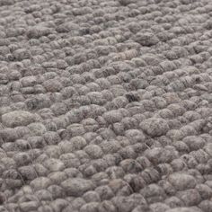 an area rug that is made out of grey wool