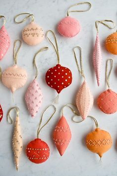 some ornaments are hanging from strings on a table