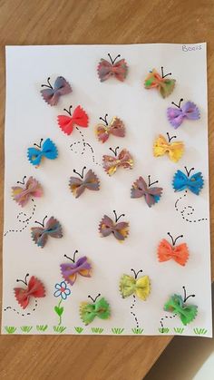 paper butterflies are arranged on a piece of white paper