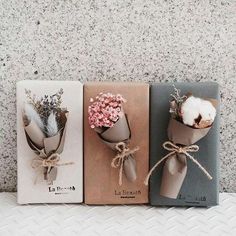 three small packages with flowers tied to them