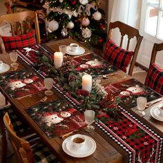 a dining room table set for christmas with plaid and pine cones on the table runner