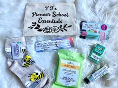 an assortment of personal care items laid out on a white blanket