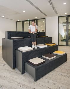 a person sitting on some steps in an office