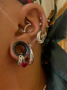 a close up of a person's ear with two different types of piercings