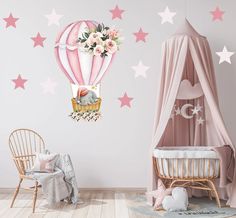 a baby's room with pink and white stars on the wall, an elephant in a hot air balloon