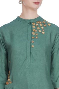 For a traditional look at work, pick this green silk blend tunic. It features 3D flower motif embroidery. Team it up with gold-toned pants to complete the look. 
Mandarin collar
Utility pockets
Three quarter sleeves - Aza Fashions Elegant Green Blouse With Floral Embroidery, Green Blouse With Floral Embroidery And Traditional Drape, Designer Green Blouse With Motifs, Green Embroidered Top With Traditional Drape, Traditional Green Blouse For Eid, Traditional Drape Green Embroidered Top, Green Anarkali Style Raw Silk Blouse, Green Anarkali Raw Silk Blouse, Green Chanderi Blouse With Floral Embroidery