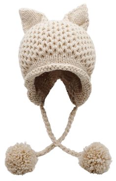 a white knitted hat with ears and pom - poms on the side