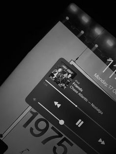 a black and white photo of a street sign with the time on it's display