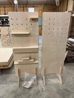 two unfinished pieces of wood sitting next to each other in a room filled with plywood