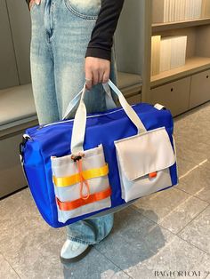 a person holding a blue and white bag