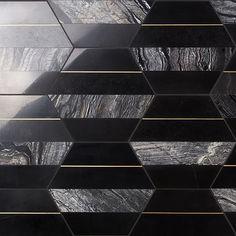 black marble and gold foiled metal hexagon tiles in an abstract pattern with metallic lines