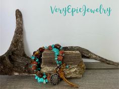 Colors of the Southwest Beaded Bracelet Turquoise and Brown Rustic Bracelet Bohemian Layered Bracele Captivating shades of turquoise and browns make this colors of the Southwest beaded bracelet. Mixed gemstones including turquoise, jasper, agate along with silver tone spacer beads,  Australian crystal beads and clay beads. This colors of the Southwest bohemian layered bracelet is finished of with beaded dangles of golden Austrian crystals, turquoise and silver tone spacer beads. The closure features a stunning button with a engraved tribal design.  These colors of turquoise, brown and gold reminds me of the Southwest! Rustic Turquoise Beaded Bracelets With Natural Stones, Bohemian Turquoise Stretch Bracelet Hand-strung, Bohemian Stretch Bracelet With Colorful Turquoise Beads, Bohemian Turquoise Stretch Bracelet With Colorful Beads, Bohemian Stretch Bracelet With Colorful Beads In Turquoise, Bohemian Turquoise Stretch Bracelet, Rustic Handmade Turquoise Beaded Bracelets, Bohemian Turquoise Stretch Bracelet For Festivals, Handmade Turquoise Bohemian Stretch Bracelet