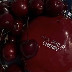 cherries are piled on top of each other with the words cherry written on them