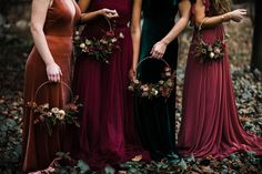 three women in long dresses standing next to each other