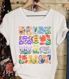 Matisse Boho Flower Shirt Wildflowers Nature Tshirt Floral T Shirt Botanical Art Nouveau Deco Gift for her  This classic Bella canvas unisex jersey short sleeve tee fits like a well-loved favorite. Soft cotton and quality print will make you fall in love with it over and over again. These t-shirts have-ribbed knit collars to bolster shaping. The shoulders have taping for better fit over time. Dual side seams hold the garment's shape for longer.  S H I P P I N G IMPORTANT: Please note that we ship to the address provided at check out. If you are ordering this as a gift and wish to have it shipped elsewhere, please enter the correct address at check out. If an incorrect shipping address was given and the gift is returned back to our shop, the customer is responsible for paying the re-shippin Cheap Oversized Floral Print T-shirt, Tabitha Swatosh Flower Shirt, Floral T Shirt, Dog Stocking, Solid Color Shirt, Flower Shirt, Botanical Art, San Jose, Bella Canvas