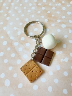 a chocolate bar keychain with a piece of s'mores on it