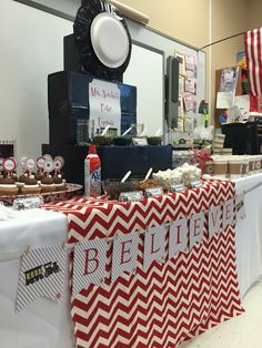 a red and white table topped with lots of food