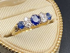 This stunning, vintage ring has it all, filigree 18K yellow gold, 3 natural prong set sapphires with 4 prong set diamonds.  This vintage beauties round center sapphire measures approx. 4.65mm, 2 smaller sapphires measure 3.5 and 3.6 mm. The 4 diamonds are also prong set and measure approx 2mm each.  The size is 9 3/4 and total weight (with stones), 4 gms.  Ring is marked "750" ( US 18K) with other hallmarks I can't make out.  750 is used in Italy to convey U.S. 18K.  The 18k yellow gold, and the Wedding Engagement Gifts, 18k Gold Ring, Finger Ring, Multi Stone Ring, Natural Sapphire, Vintage Ring, Vintage Beauty, Sapphire Diamond, Gold Band