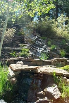 there is a small waterfall in the middle of some rocks