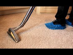 a person using a vacuum to clean carpet