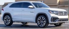 a white volkswagen suv parked in a parking lot