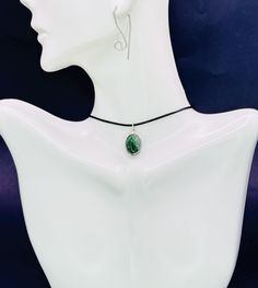 Elevate your style with our Nephrite Necklace, a stunning Y2K-inspired piece that combines timeless elegance with modern flair. This protection amulet features a beautiful jade pendant, symbolizing purity and serenity. The jade string choker, crafted with a durable black cord, offers a sleek and versatile design perfect for any occasion. Whether worn as a jade necklace or a chic black cord choker, this accessory adds a touch of sophistication to your look. The protective properties of jade make it an ideal choice for those seeking both beauty and spiritual balance. Discover the allure of this exquisite piece and embrace the calming energy of jade today. Details: *Handmade item, gift wrap *Ships from Florida, USA *Materials: cord, Sterling Silver charm, Nephrite         Pendant width:  12 m Oval Jade Cabochon Necklaces, Oval Jade Cabochon Necklace, Jade Cabochon Oval Pendant Necklace, Round Jade Cabochon Pendant Necklace, Jade Cabochon Round Pendant Necklace, Green Cabochon Oval Pendant Necklace, Jade Cabochon Pendant Necklace, Silver Jade Cabochon Necklace, Silver Necklace With Jade Cabochon