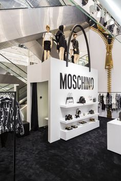 the moschino store is filled with mannequins and handbags on display