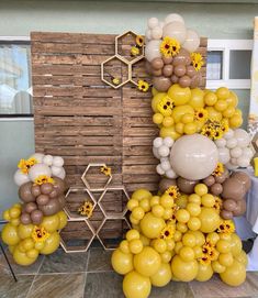 balloons and sunflowers are arranged in the shape of a pyramid on a table