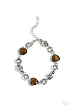 Heart-shaped tiger's eye stones and sleek silver hearts alternate along the neckline from a double strand of shimmery silver chains. Bubbly textured silver rings separate each heart shape infusing the romantically earthy design with a touch of high-sheen detail. Features an adjustable clasp closure. As the stone elements in this piece are natural, some color variation is normal.   Sold as one individual necklace. Includes one pair of matching earrings.  I Can Feel Your Heartbeat Brown  Bracelet Earthy Design, Brown Tiger Eye, Silver Heart Bracelet, Brown Bracelet, Jewelry Catalog, Heart Shaped Earrings, Paparazzi Accessories, Tiger Eye Stone, Paparazzi Jewelry