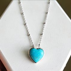 "This stunning necklace is the perfect gift for your loved ones. Crafted from sterling silver, it features a delicate ball chain with a beautiful turquoise pendant. The pendant is a blue turquoise color with subtle variations in the color, making it a unique and eye-catching piece. The dainty chain allows the necklace to rest gracefully on the neckline and adds a touch of feminine elegance that will make any look shine. Length: adjustable 16-18\" Chain: sterling silver / hypoallergenic stainless Dainty Turquoise Necklace For Gift, Sterling Silver Turquoise Necklace Gift, Turquoise Necklace With Delicate Chain For Gift, Turquoise Sterling Silver Jewelry With Delicate Chain, Dainty Turquoise Sterling Silver Necklace, Dainty Turquoise Charm Necklace For Gift, Minimalist Turquoise Charm Necklace For Gift, Turquoise Sterling Silver Necklace With Delicate Chain, Dainty Turquoise Pendant Necklace Gift