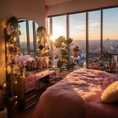 a bedroom with a pink bed and large windows overlooking the cityscape at sunset