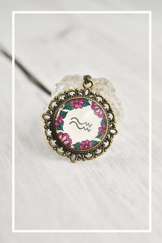 Your zodiac necklace collection is not complete without a floral Aquarius necklace water sign. Handmade with whimsical, cute miniature art and a vintage style, this Aquarius pendant ignites your inner magic. The Aquarius jewelry is painted by hand, making each piece unique and one of a kind, just like you. Click through to see more glass pendant necklaces! Horoscope Aquarius