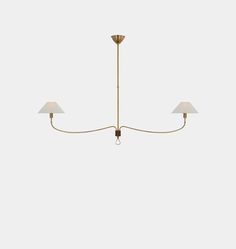 three light brass chandelier with white shades on the top and bottom, in an elegant style