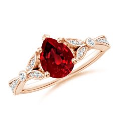 a ring with a red stone and white diamonds on the band, set in 18k rose gold